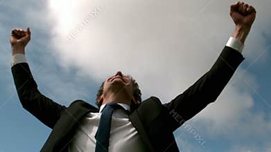 Handsome businessman put his hands up