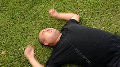 A fat bald head Asian Thai man is acting wriggling like a spoil child having seizures with angry aggressive face or having mental