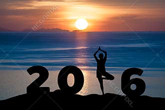 Silhouette young woman play Yoga on the sea and 2016 years while celebrating new year