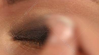 Make-up artist applying bright base color