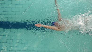 Above view of swimmer diving into pool