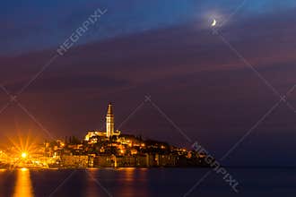 Rovinj old town at night with moon on the colorful sky, Adriatic sea coast of Croatia, Europe