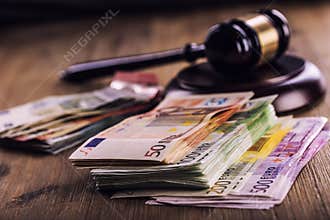 Justice and euro money. Euro currency. Court gavel and rolled Euro banknotes. Representation of corruption and bribery in the judi