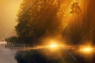 Sunshine in misty lake
