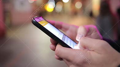 A Close Up of Texting or Emailing on Smart Phone in a City Street
