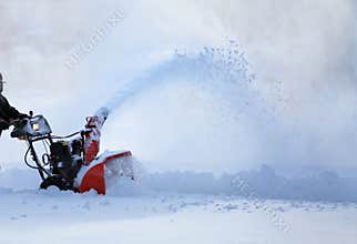 Man working with snow blower