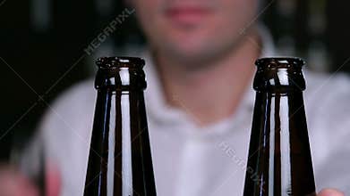 Removing the caps from bottles of beer closeup