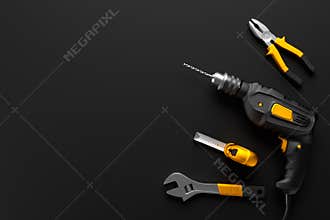 Drill, wrench and construction tools on the black background