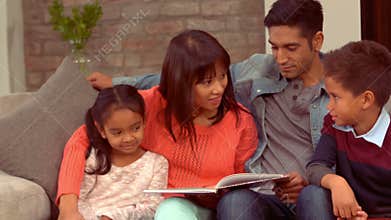 Smiling Hispanic family in the living room