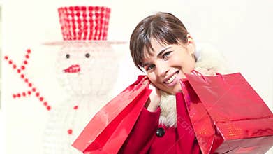 Christmas woman with red bags, smiles, shopping concept