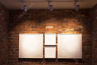 Boards in frames on brick wall
