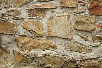 Photo of detail of castle stone wall in brown and beige tone