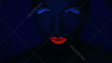 Woman face with fluorescent make up