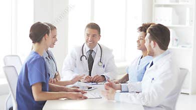 Group of happy doctors making high five at clinic