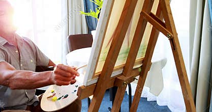 Portrait of retired person in wheel chair painting