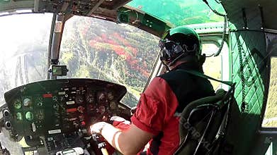 Helicopter approaching airfield in cockpit sight Austrian Alps.