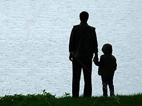 Man and child silhouette at evening