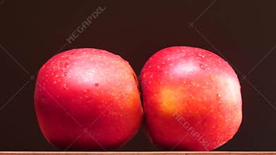 Abstaract sexual act perforance with apples on black background