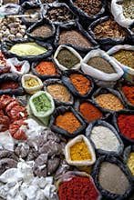 A colurful selection of spices, herbs and nuts for sale at a market stall in the Indian market in Otavalo in Ecuador.