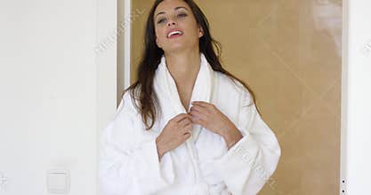 Gorgeous female adult adjusting bath robe