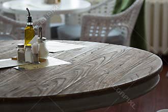 Restaurant interior. Pepper and salt on the table.