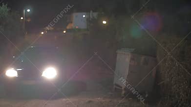 Car driving in the gloomy countryside at night