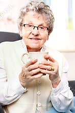 old lady drinking a brew of herbs