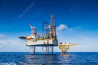 Oil and gas drilling rig work over remote wellhead platform to completion oil and gas produce well