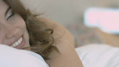 Seductive model in the silk nightie lying on the bed
