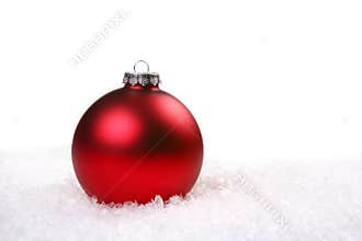 Single Red Shiny Christmas Ornament in the Snow