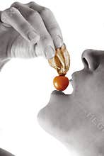 Woman eating Physalis