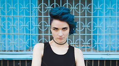 Street punk or hipster girl with blue dyed hair.