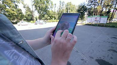 Pokemon Go app being played by a man on his tablet.
