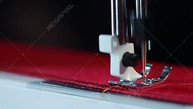 Electric sewing machine embroider on fabric. Sewing needle stitching on fabric