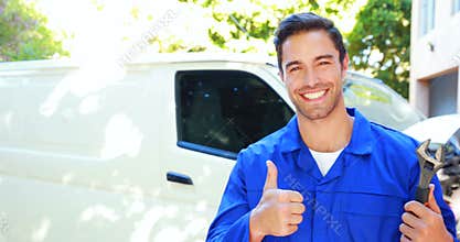 Repairman with tools and thumbs up