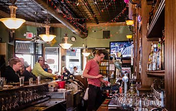 A young guy works in a bar