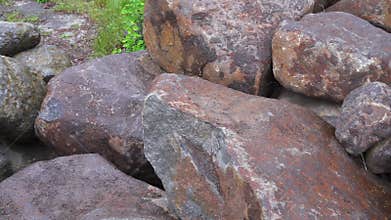 Group of big boulder stones lying in field, natural geologic background