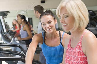 Personal Trainer Showing Woman On Treadmill