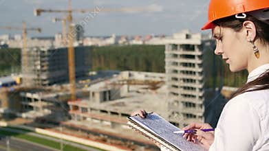 Woman architect checks with the construction plan