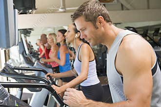 Man Running On Treadmill At Gym