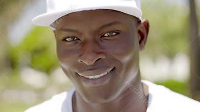 Close up of handsome smiling black man in cap