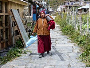 Nepalese Monk Woman with Toilet Bowl in Manang Village, Nepal