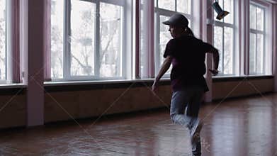 A female professional breakdancer performing in the dance studio, The dark silhouette of dancing girl