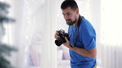 Young photographer with beard making photo