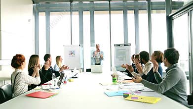 Creative director giving motivational speech, everybody is clapping