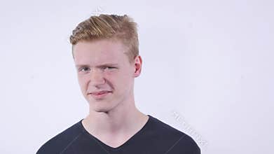 Portrait of boy disgusted by something over white background.Negative expression.