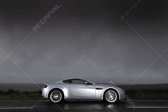Sports car under stormy sky