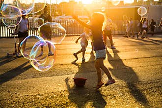 Children blowing bubbles and playing