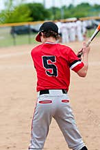 Young teen baseball player from behind