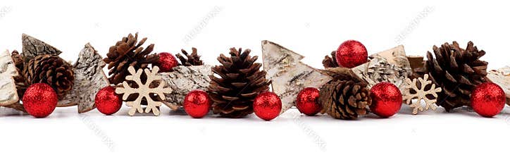 Christmas border with rustic wood tree ornaments, baubles and pine cones isolated over white